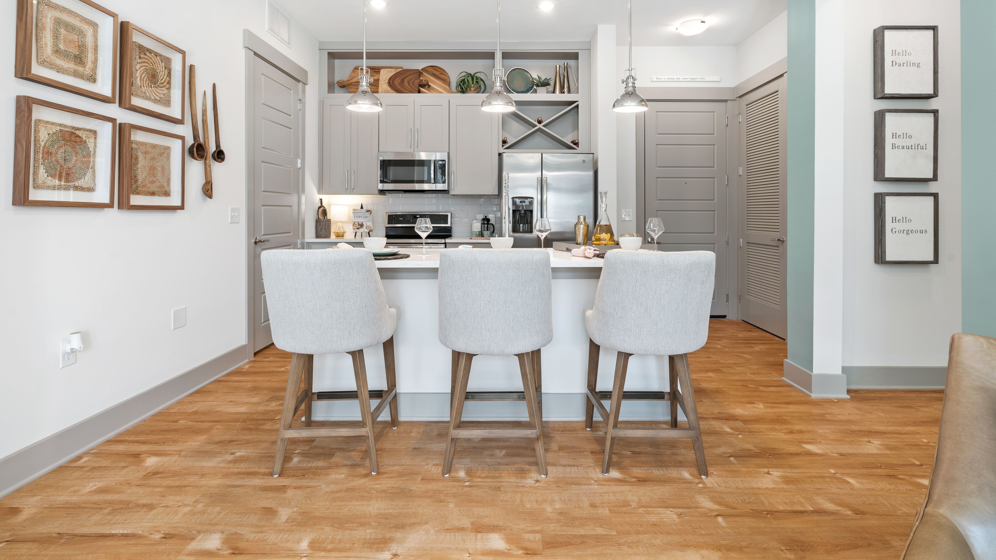 Hawthorne at Friendly apartment living room with large patio doors, furnished with a couch, coffee table, and chair