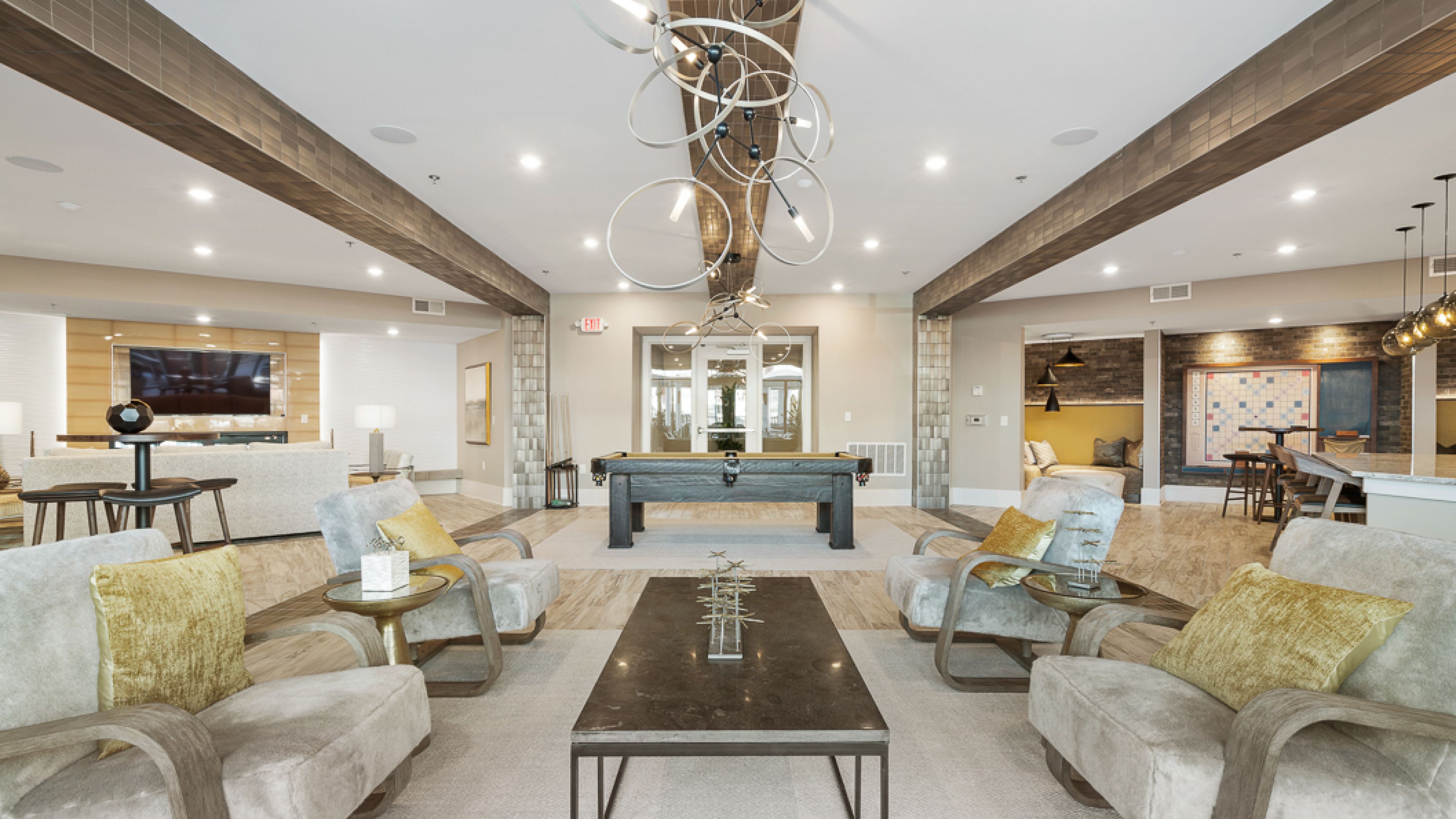 Hawthorne at Friendlyluxurious common area featuring modern furniture, a pool table, and a unique circular chandelier.